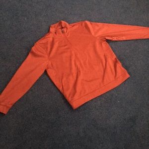 A red GrandSlam Performance sweater